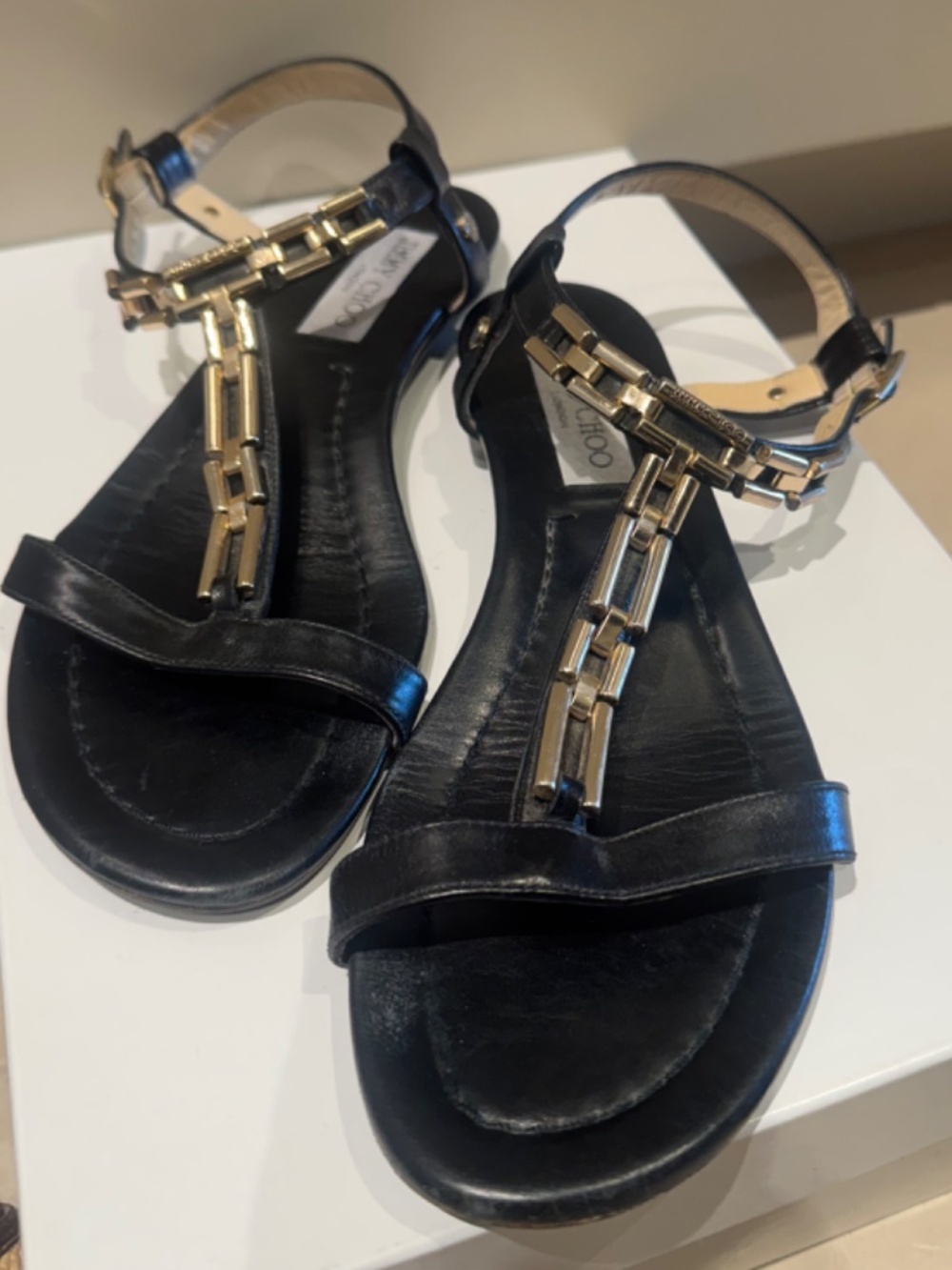 JIMMY CHOO Narcissa Black & Gold T Strap Leather Sandal with Gold Chain Detail